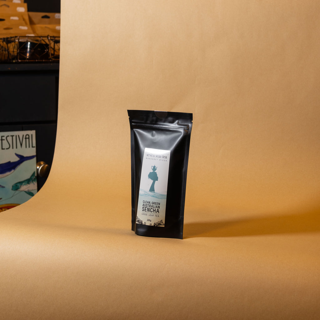 Green Australian Sencha pouch on a brown paper backdrop, Seven Seas Tea Margaret River