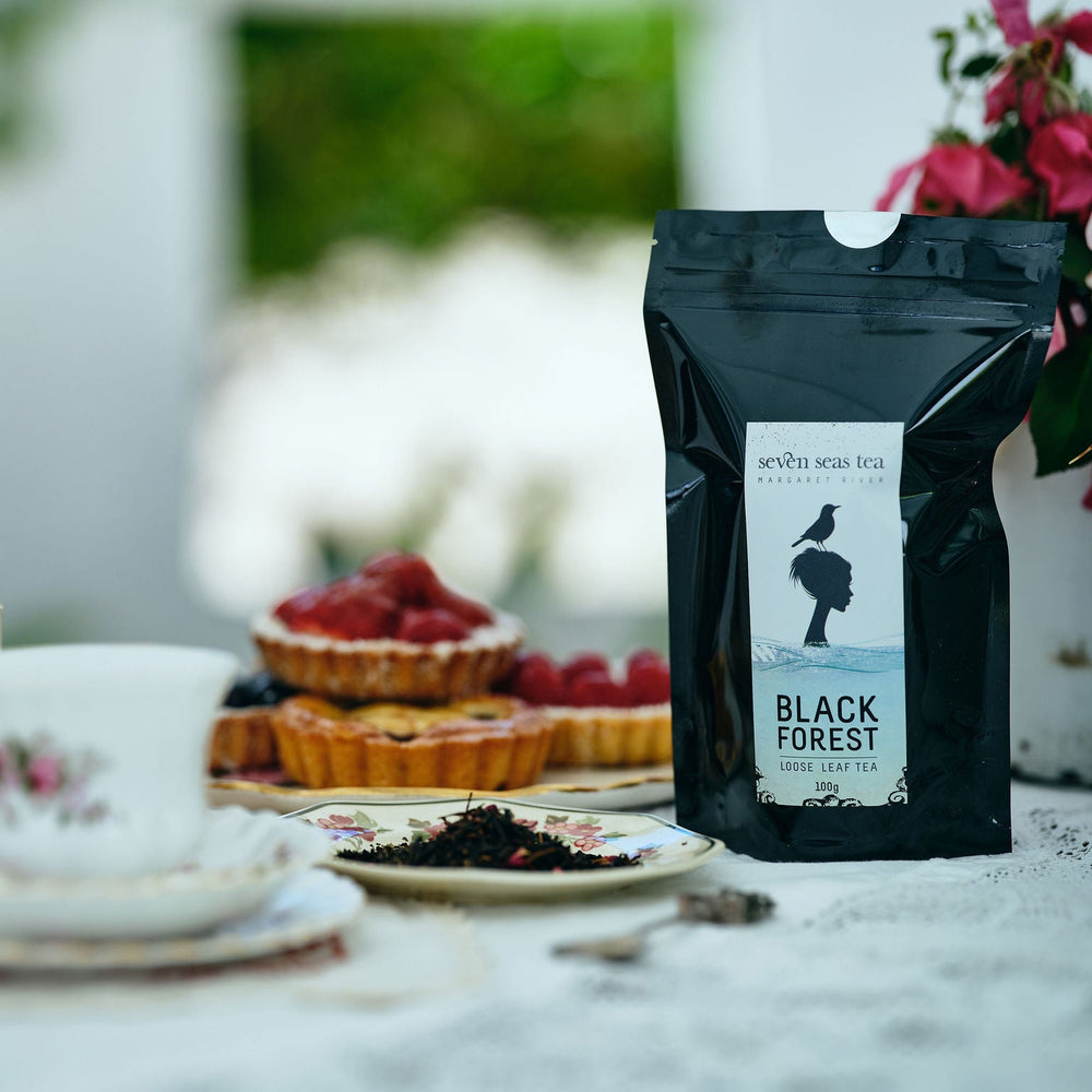 Black Forest tea on a table with tea cups and pastries