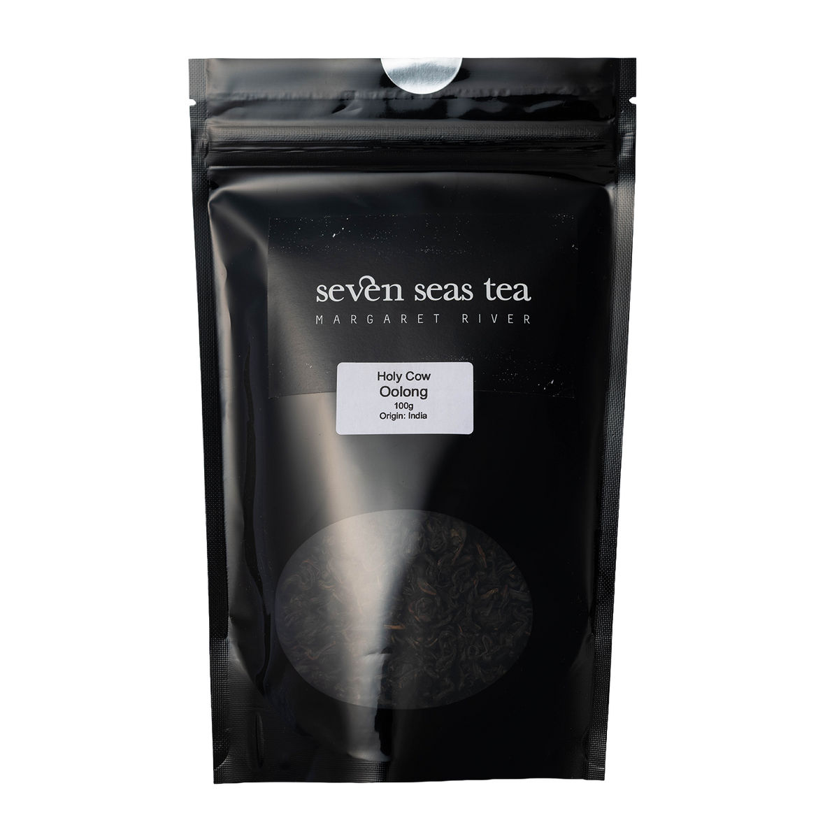 Black Seven Seas Tea pouch of Holy Cow Indian Oolong with a window showing the leaf