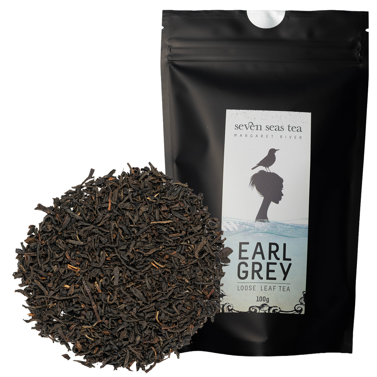 Loose leaf Organic Earl Grey piled beside its black Seven Seas Tea pouch