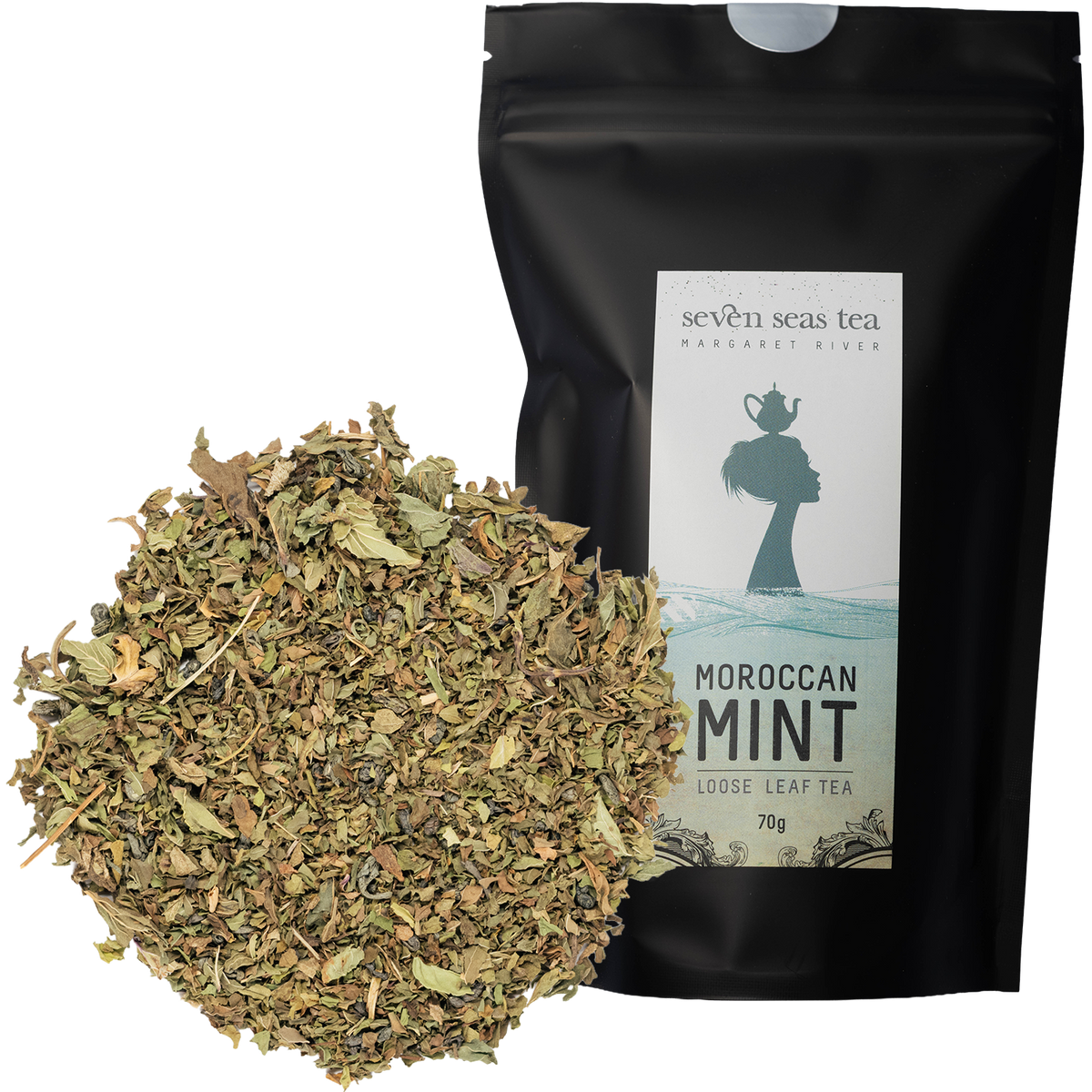 Loose leaf Organic Moroccan Mint piled beside its black Seven Seas Tea pouch