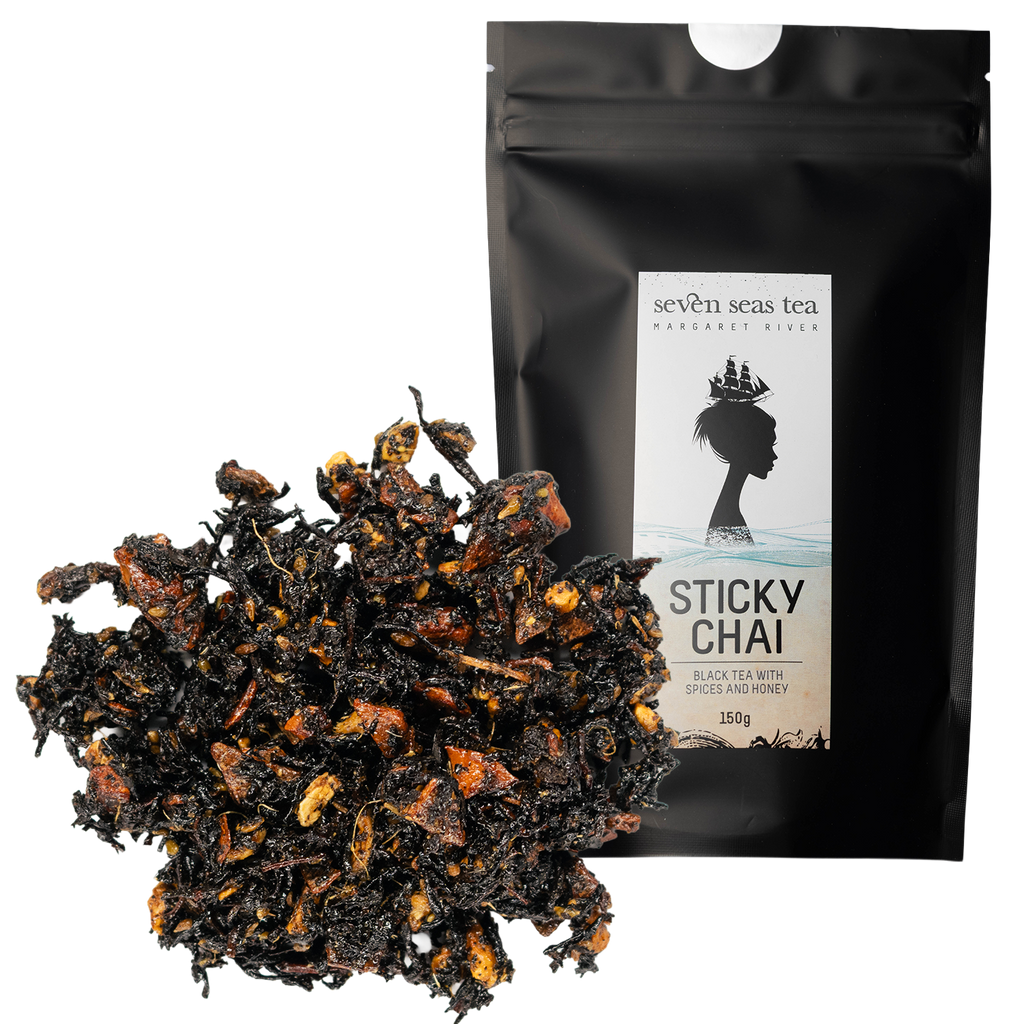 Loose leaf Organic Sticky Chai piled beside its black Seven Seas Tea pouch
