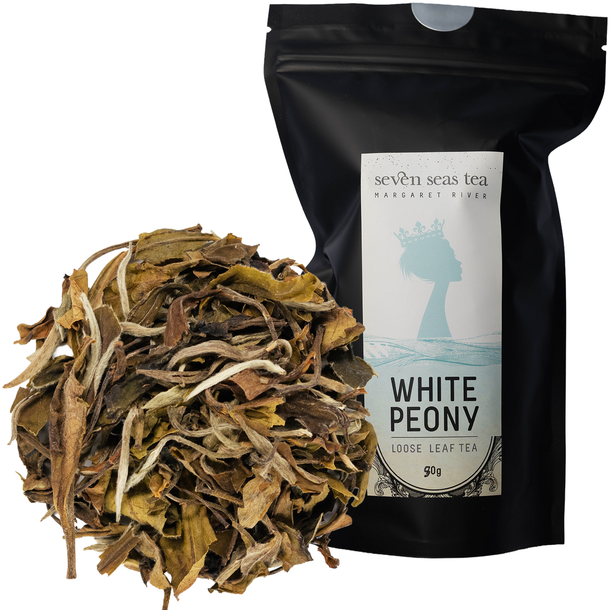 Loose leaf White Peony piled beside its black Seven Seas Tea pouch