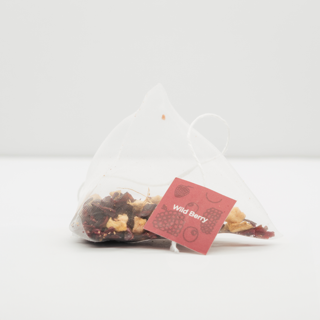 A single Organic Wildberry Teabags pyramid teabag with its paper tag