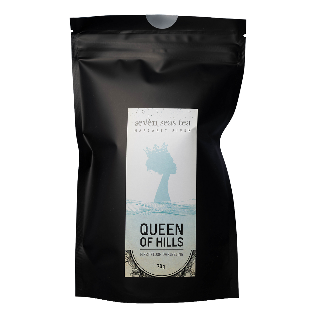 Black pouch of Queen Of Hills Premium First Flush Darjeeling with a window showing the leaf