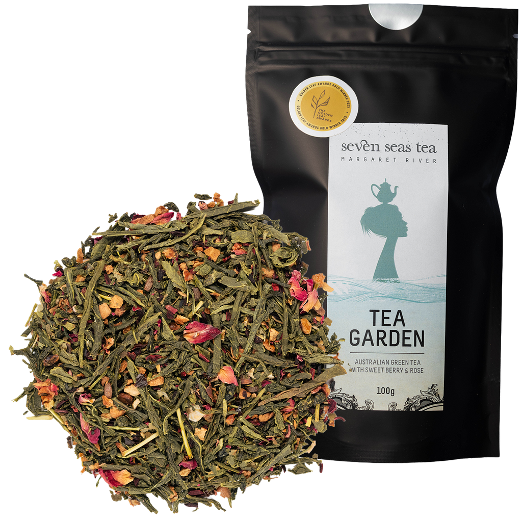 Tea Garden green tea loose leaf piled beside its black pouch with a medal sticker